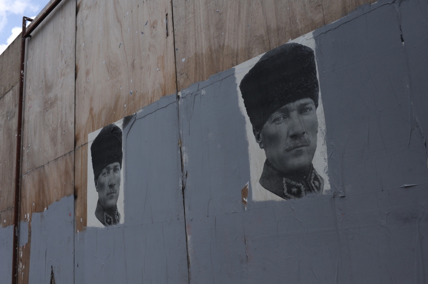 Posters of Mustafa Kemal Ataturk surrounded by painted over graffiti are seen near Taksim Square in Istanbul, Turkey on June 13, 2013.  On the 17th day of protest and periodic riots in Istanbul, many awoke to find graffiti opposing the ruling Justice and Development Party, known by its Turkish acronym AKP, had been painted over by municipal workers overnight.