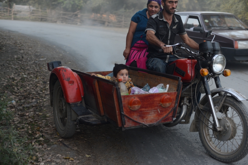 An Avar family is seen riding in a motorcycle and a side car along a main street in the Avar village of Danaci, Azerbaijan on September 14, 2013.