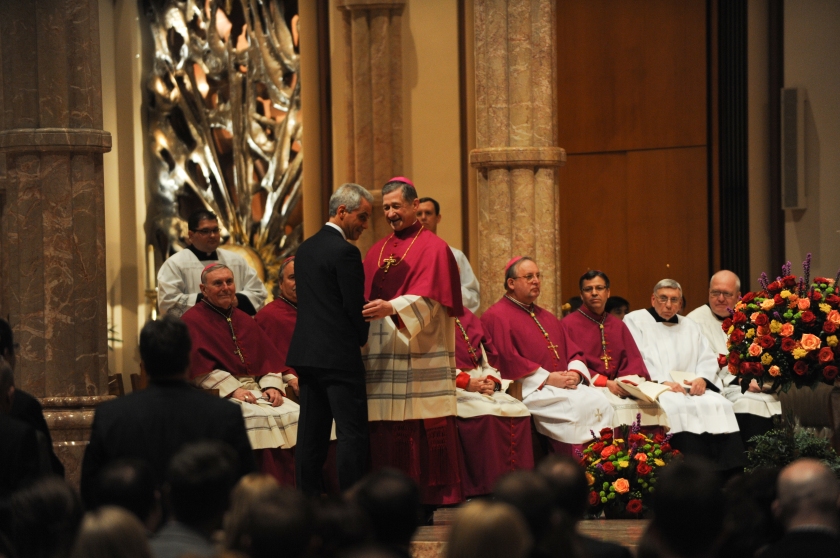 Chicago Mayor Rahm Emanuel leads a line of civic and state leaders in greeting the new Archbishop-elect Blase Cupich at the start of the mass ahead of Cupich's installation ceremony at Holy Name Cathedral in Chicago, Illinois on November 18, 2014.  Cupich is the ninth Archbishop of Chicago and succeeds Cardinal Francis George.
