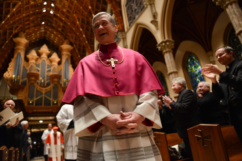 The Archbishop-elect of Chicago, Blase Cupich, enters the mass ahead of his installation ceremony after ceremoniously knocking on the door at Holy Name Cathedral in Chicago, Illinois on November 18, 2014.  Cupich is the ninth Archbishop of Chicago and succeeds Cardinal Francis George.