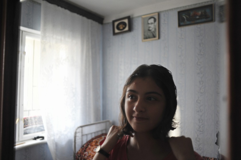 Gamar Tagili, 15, after a shower prepares to get ready to say goodbye to her brother, Asiman Tagili, 20, in the family bedroom hours before he leaves to the western part of the country to fulfill his military service obligations in Baku, Azerbaijan on July 5, 2012.